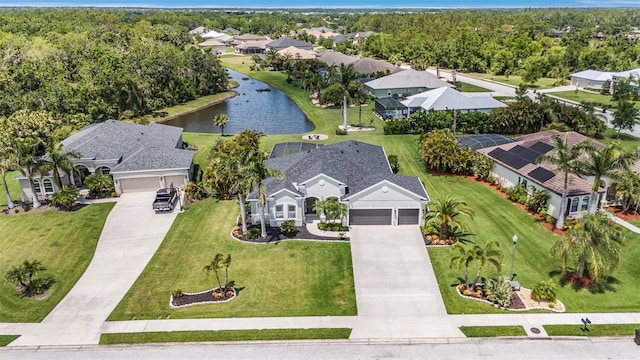birds eye view of property featuring a water view and a residential view