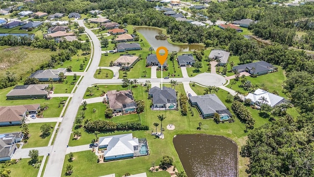 drone / aerial view with a water view and a residential view