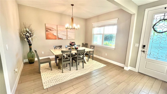 13422 Flat Woods Ter, Bradenton, FL 34211 - dining room with light wood finished floors, baseboards, and a chandelier