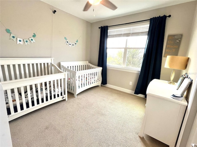 13422 Flat Woods Ter, Bradenton, FL 34211 - carpeted bedroom featuring a crib, baseboards, and ceiling fan