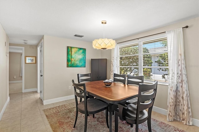 dining space with baseboards, light tile patterned flooring, and visible vents