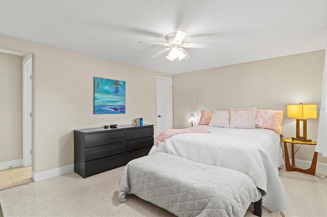 bedroom with speckled floor, baseboards, and ceiling fan