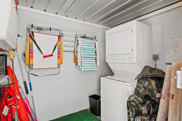 clothes washing area featuring laundry area and stacked washer / drying machine