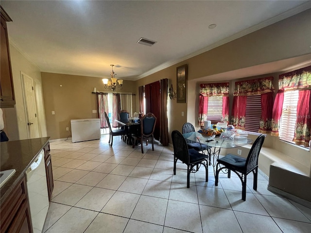 dining room with crown molding, light tile patterned floors, a chandelier, and visible vents