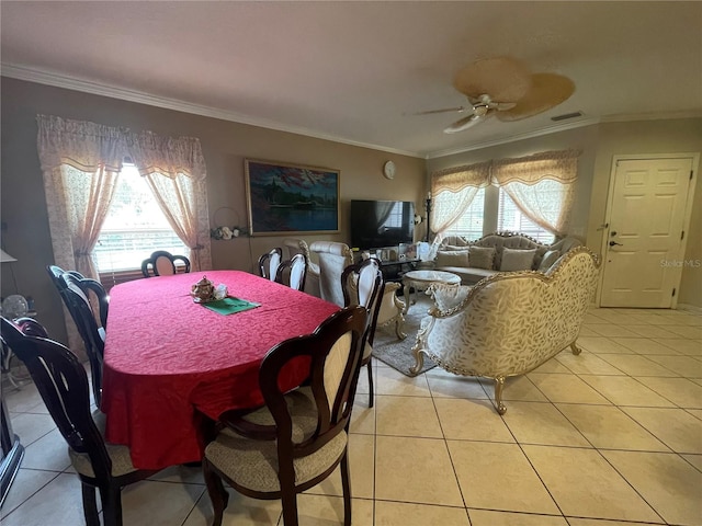 dining space with crown molding, a ceiling fan, visible vents, and light tile patterned floors