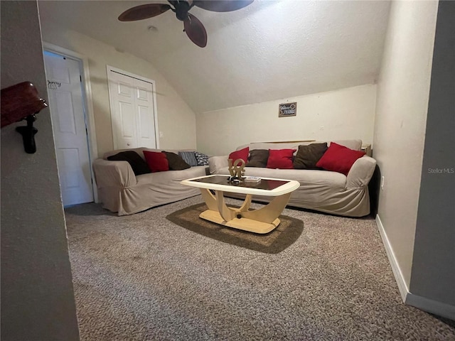 living area featuring carpet floors, ceiling fan, baseboards, and lofted ceiling