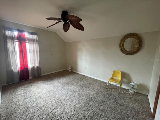 interior space with baseboards, carpet, a ceiling fan, and lofted ceiling