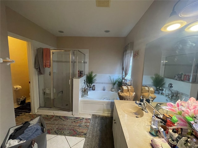bathroom featuring visible vents, vanity, tile patterned flooring, a bath, and a shower stall
