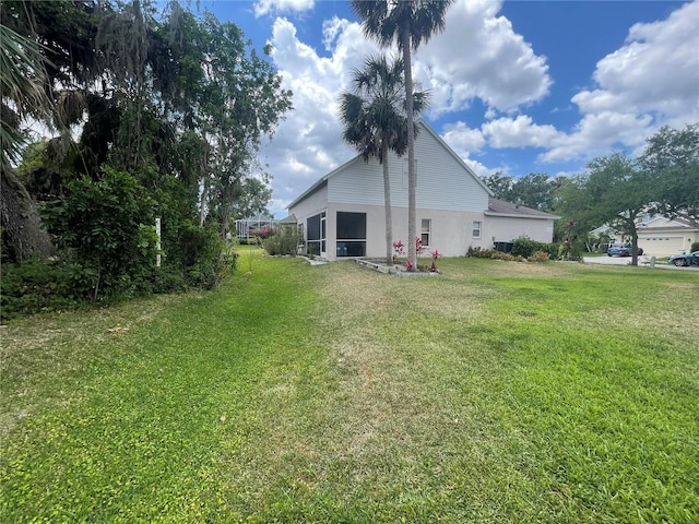 back of house featuring a lawn and stucco siding