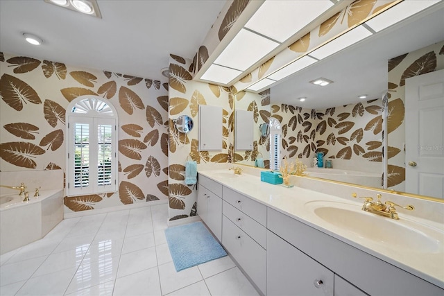 bathroom featuring wallpapered walls, a garden tub, double vanity, tile patterned floors, and baseboards