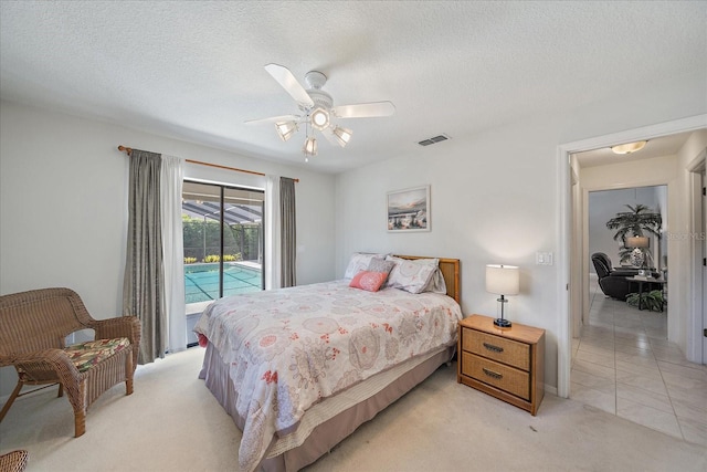 bedroom featuring access to exterior, light carpet, ceiling fan, and a textured ceiling