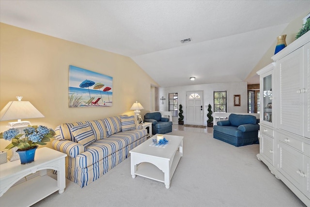 carpeted living room with lofted ceiling