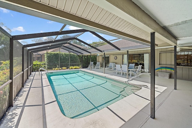 swimming pool featuring a patio and glass enclosure