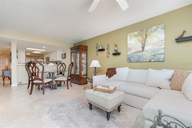 living room with light tile patterned floors, ceiling fan, and healthy amount of natural light