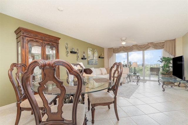 dining area featuring light tile patterned flooring and a ceiling fan