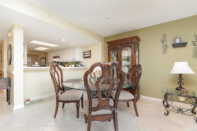 dining room featuring light tile patterned flooring, baseboards, and recessed lighting