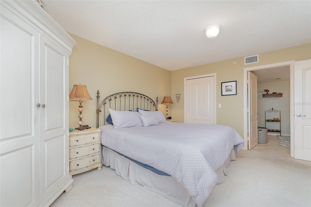 bedroom featuring light carpet and a closet
