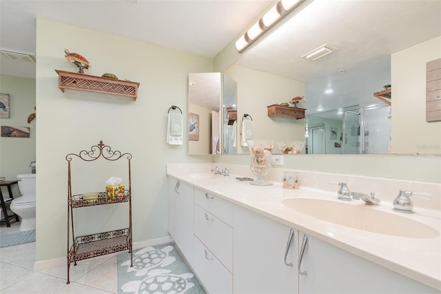 bathroom featuring a shower stall, tile patterned floors, double vanity, toilet, and baseboards