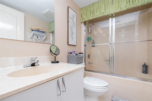 bathroom featuring toilet, bath / shower combo with glass door, and vanity