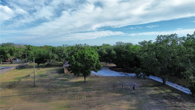 view of yard featuring fence and a rural view