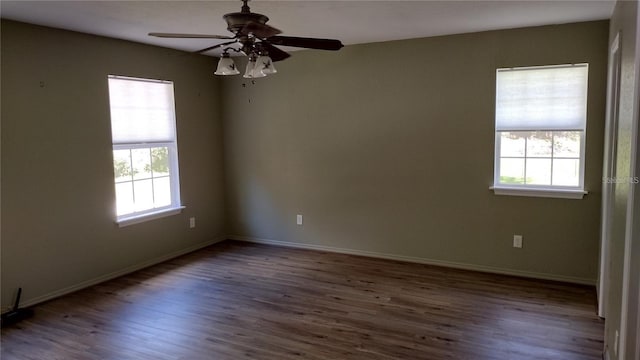 spare room featuring a healthy amount of sunlight, ceiling fan, and wood finished floors