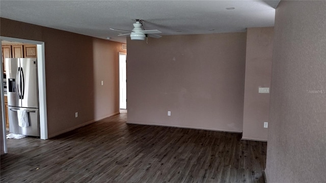 unfurnished room featuring dark wood-style flooring, baseboards, and a ceiling fan