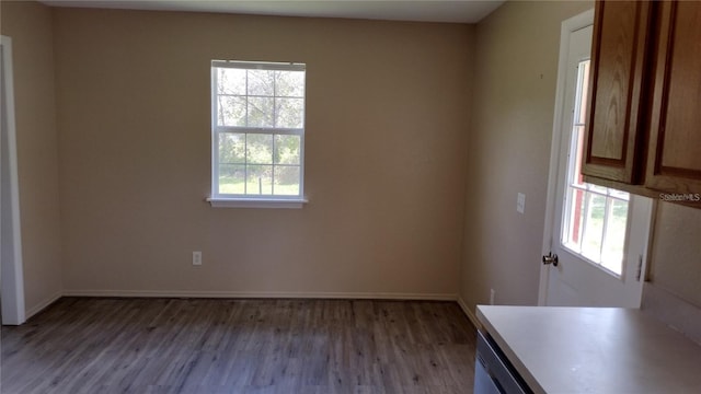 unfurnished room with baseboards and wood finished floors