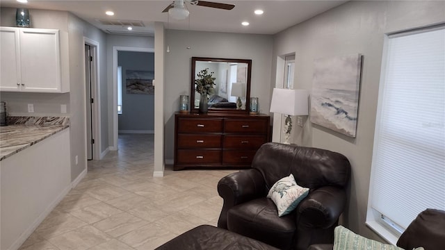 living area featuring a ceiling fan, visible vents, baseboards, light tile patterned flooring, and recessed lighting