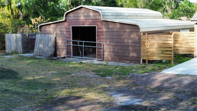 view of outbuilding featuring an outbuilding and fence