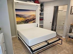 bedroom with baseboards and a closet