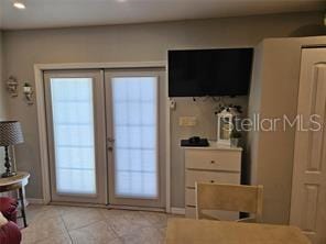interior space featuring multiple windows, light tile patterned flooring, and recessed lighting