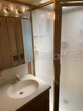 full bath with walk in shower and vanity