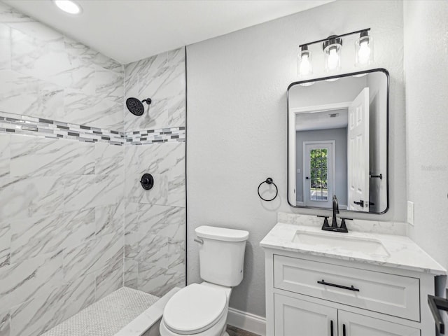 8304 Fishhawk Ave, New Port Richey, FL 34653 - bathroom featuring vanity, toilet, and tiled shower
