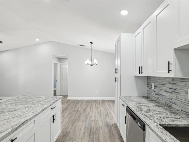 8304 Fishhawk Ave, New Port Richey, FL 34653 - kitchen featuring a notable chandelier, dishwasher, white cabinetry, lofted ceiling, and tasteful backsplash