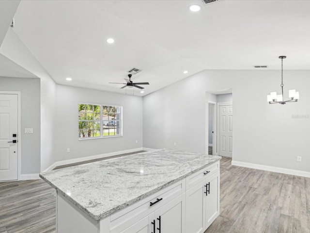 8304 Fishhawk Ave, New Port Richey, FL 34653 - kitchen with light wood-style floors, white cabinets, recessed lighting, and visible vents