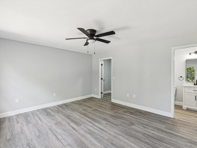 8304 Fishhawk Ave, New Port Richey, FL 34653 - interior space featuring a ceiling fan, baseboards, and wood finished floors