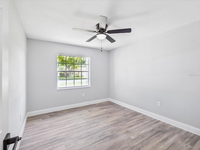 8304 Fishhawk Ave, New Port Richey, FL 34653 - empty room featuring baseboards, a ceiling fan, and wood finished floors