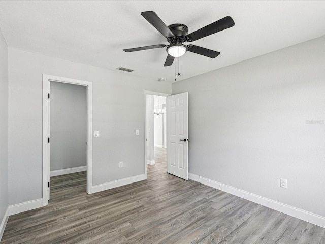8304 Fishhawk Ave, New Port Richey, FL 34653 - unfurnished bedroom with baseboards, wood finished floors, and visible vents