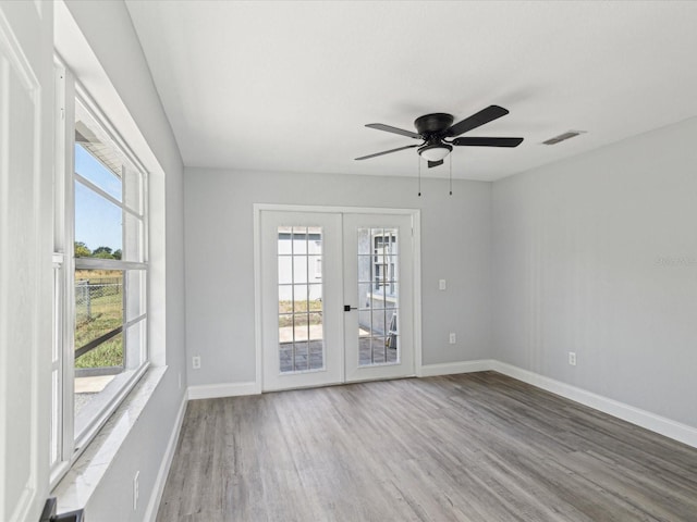 8304 Fishhawk Ave, New Port Richey, FL 34653 - unfurnished room featuring a ceiling fan, baseboards, visible vents, and wood finished floors