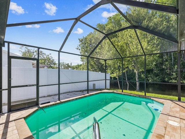8304 Fishhawk Ave, New Port Richey, FL 34653 - view of swimming pool with glass enclosure, a patio, a fenced in pool, and a fenced backyard