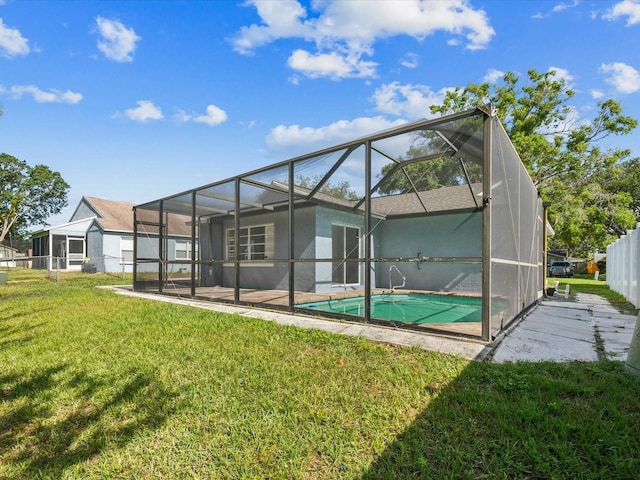 8304 Fishhawk Ave, New Port Richey, FL 34653 - back of house featuring a yard, an outdoor pool, glass enclosure, and stucco siding
