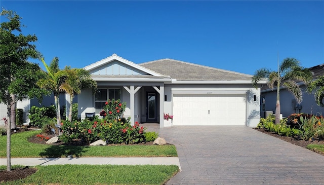 26017 Seastone Dr, Englewood, FL 34223 - ranch-style house featuring an attached garage, driveway, and stucco siding