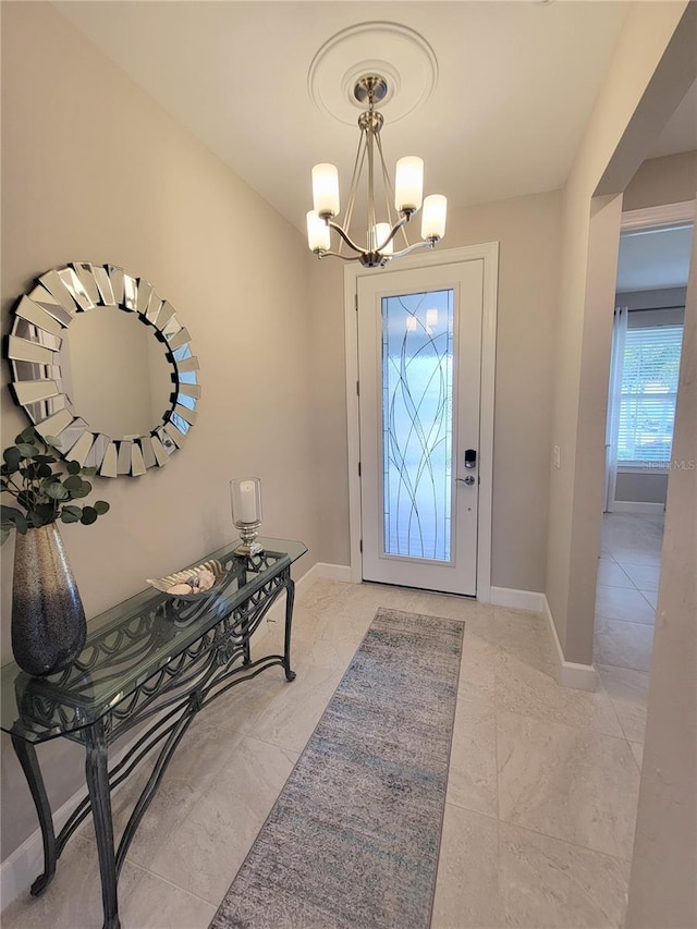 26017 Seastone Dr, Englewood, FL 34223 - foyer featuring a chandelier and baseboards