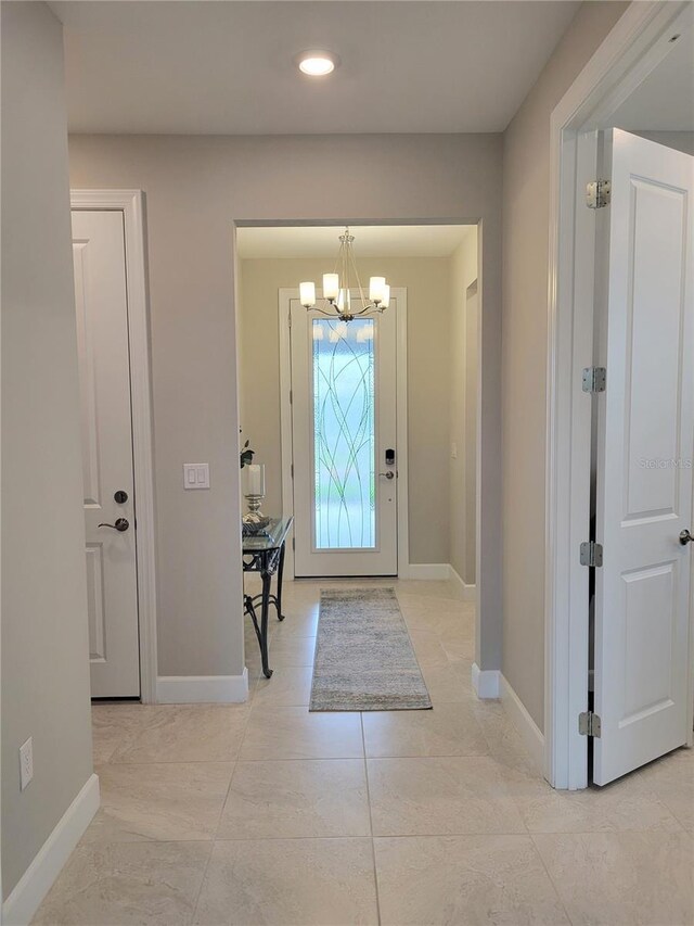 26017 Seastone Dr, Englewood, FL 34223 - entrance foyer featuring a chandelier, baseboards, and recessed lighting