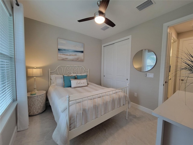 26017 Seastone Dr, Englewood, FL 34223 - bedroom with a closet, a ceiling fan, and baseboards