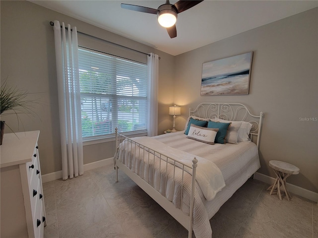 26017 Seastone Dr, Englewood, FL 34223 - bedroom featuring baseboards and ceiling fan