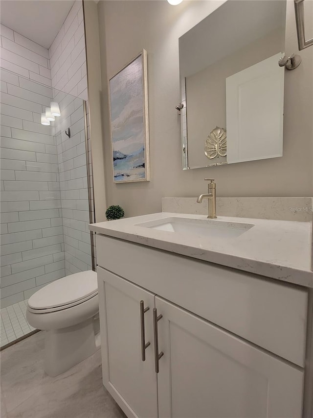 26017 Seastone Dr, Englewood, FL 34223 - bathroom with vanity, toilet, and tiled shower