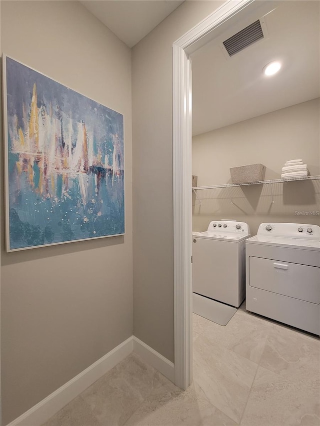 26017 Seastone Dr, Englewood, FL 34223 - laundry room with washing machine and clothes dryer and baseboards