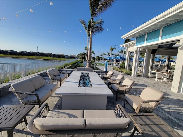 26017 Seastone Dr, Englewood, FL 34223 - view of patio featuring an outdoor living space with a fire pit and a water view