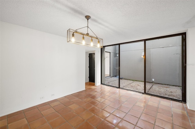 unfurnished dining area with tile patterned flooring and a textured ceiling